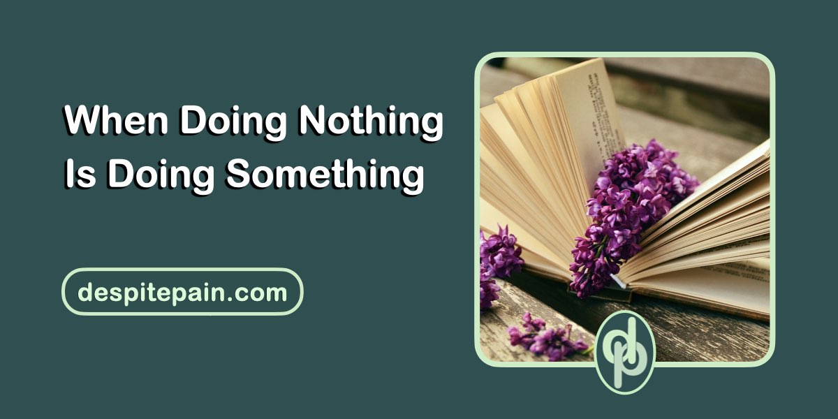 When doing nothing is doing something. The image contains a photo of an open book with some purple flowers laid on top.